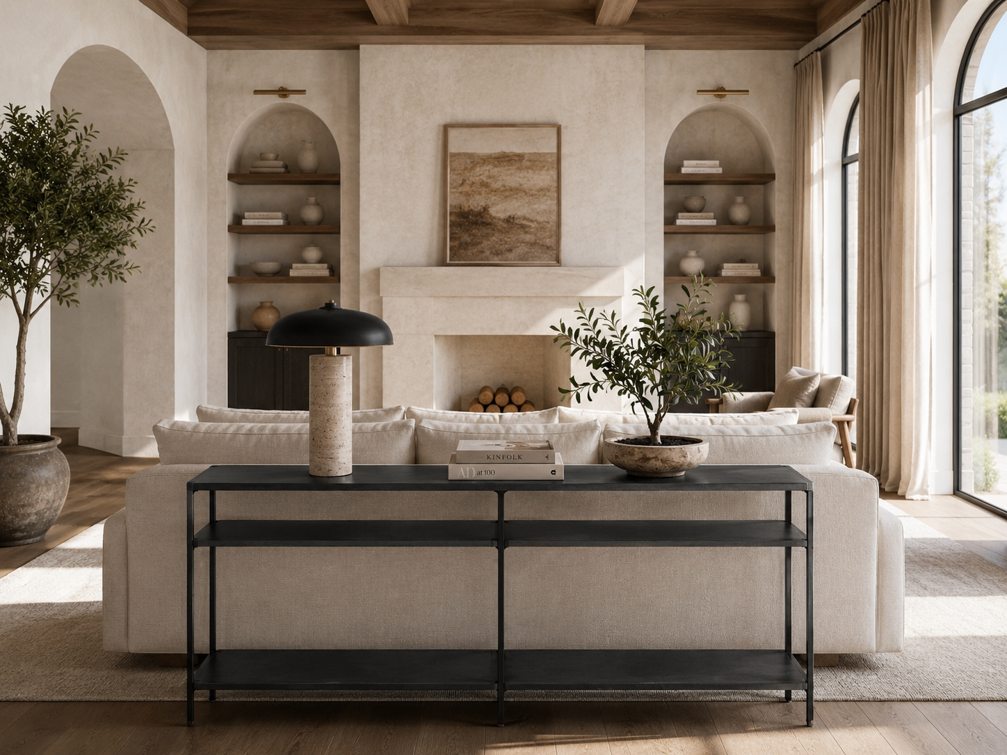 Organic modern living room with console behind a floating linen sofa, flanked by stone lamps and architectural shelving